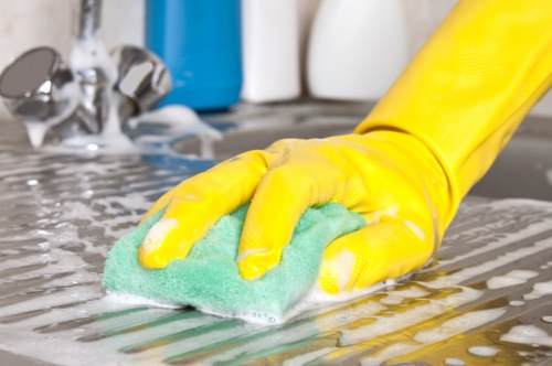 Local rug cleaner treating stains and dirt on a living room rug in Wimbledon